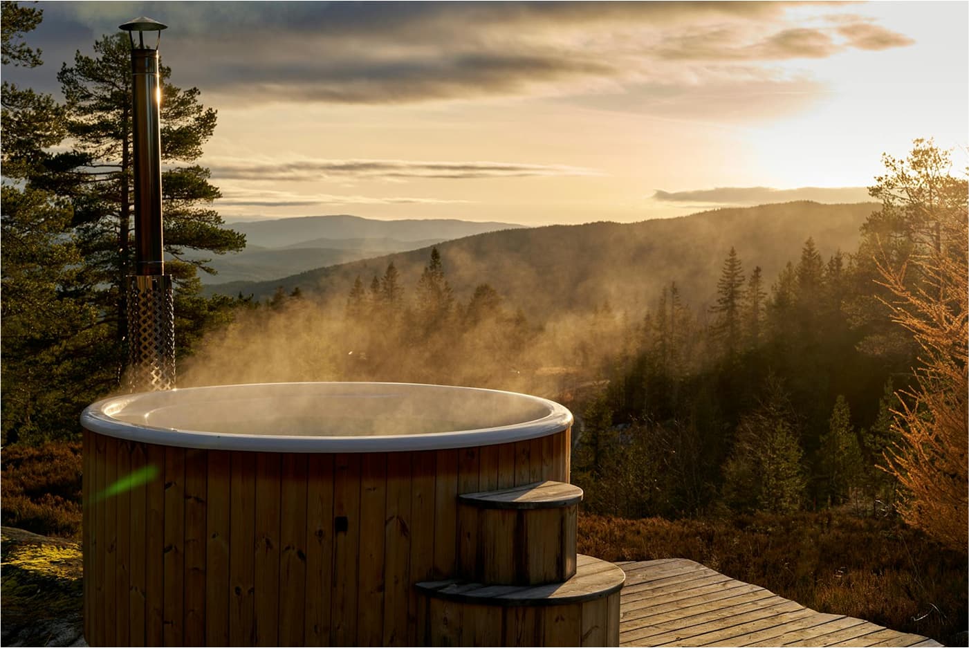 a steaming hot tub in the mountains
