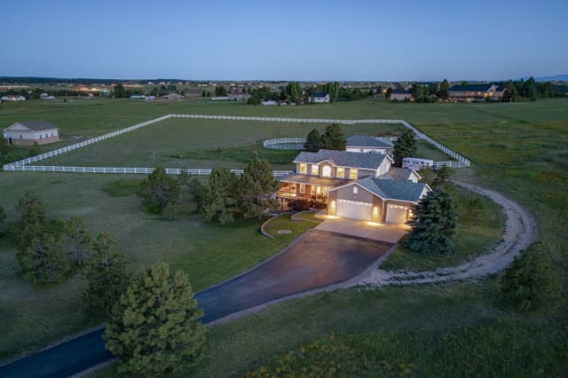 an aerial photo of a home exterior at dusk